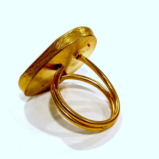 Anello in metallo dorato con pietra a goccia